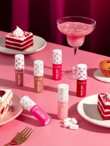 A playful and indulgent flatlay for a "Sugar Rush" themed cosmetic launch. We surrounded the products with red velvet cake, pastries, and a slushie to create a delicious, candy inspired world that perfectly matches the product names and branding.