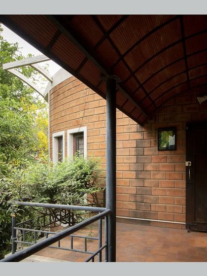 Another view of the balcony, showing its connection to the curved brick wall of the main structure.