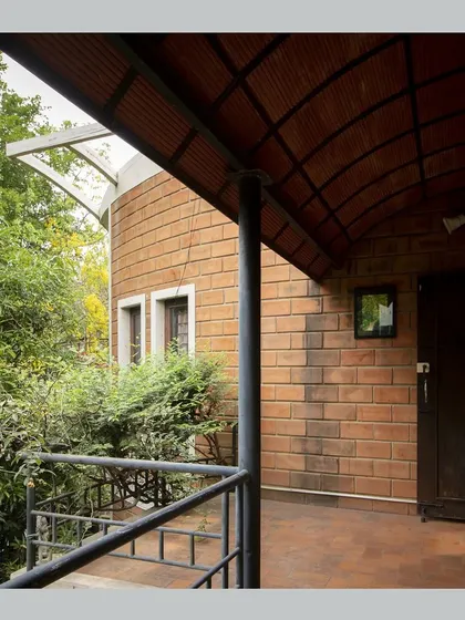 Another view of the balcony, showing its connection to the curved brick wall of the main structure.