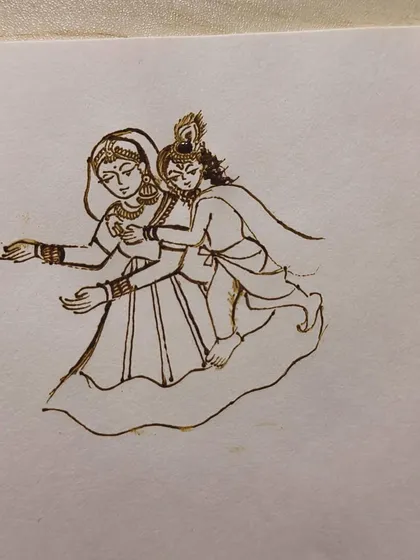We start with practicing figures on paper to build muscle memory. This is a Radha Krishna design, a classic motif in bridal mehendi.