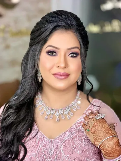 A close-up showing her beautiful smile and the intricate hathphool that adds a touch of tradition to her modern engagement look.