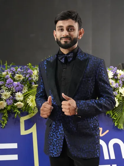 Ready for the spotlight at a recent stage show. The floral arrangements and stage branding show the scale of events I am accustomed to hosting.