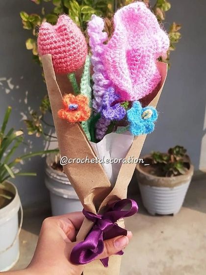 This custom bouquet features a mix of a pink tulip, a large pink flower, and smaller complementary flowers in orange, purple, and blue. It showcases our ability to combine different flower types and colors to match your vision.