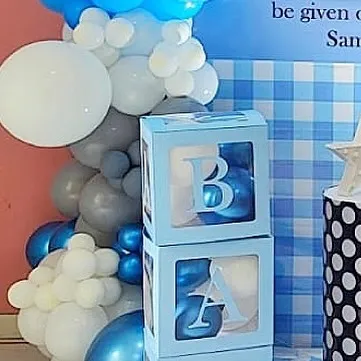 Detail of a Boss Baby setup, showing the 'BABY' blocks and the blue and grey balloon garland.