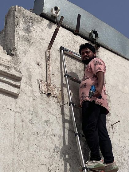 Ready to install another camera on a warehouse exterior. We work systematically to cover all designated security zones.