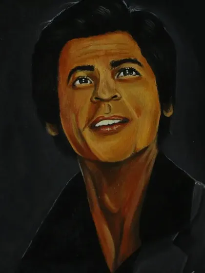 The full view of my SRK portrait on an easel, showing the warm tones and detailed work that went into capturing his likeness.