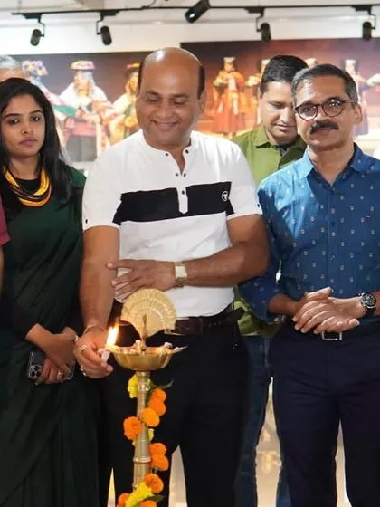 Lighting the lamp to inaugurate the 'Sanskruti Yatra' photography exhibition at Reachout Art Gallery in Nashik.