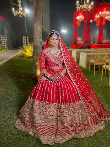 A full portrait showcasing the grandeur of her bridal attire. The makeup provides a perfect, polished finish to her regal look.