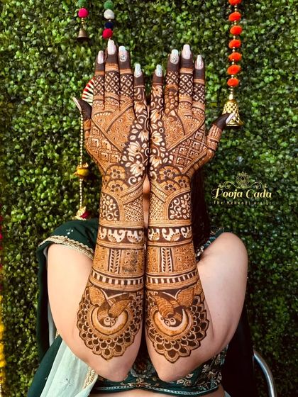 My beautiful NRI bride from Dubai showing off her intricate back-hand mehendi design.