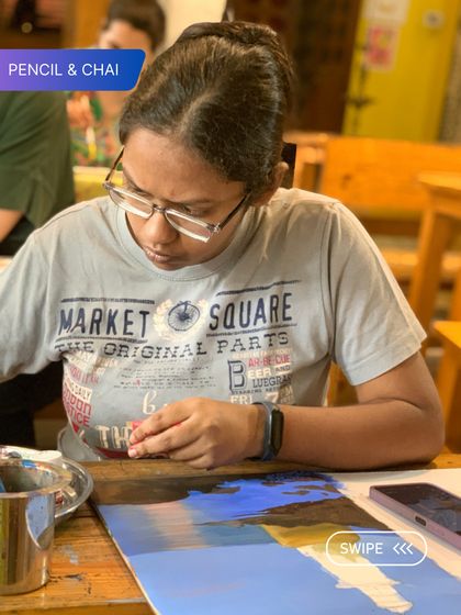 A student works on a landscape painting, capturing the reflection of the sky on water. The focused environment of our classroom helps artists tackle complex subjects with confidence.