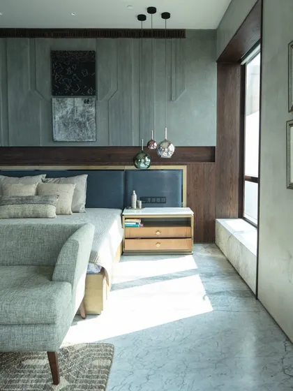 This master bedroom in our Kolkata project was designed as a serene retreat with panoramic views of the Victoria Memorial. Natural light floods the space, highlighting the etched basalt stone headboard and a curated selection of art. The material palette of stone, wood, and soft textiles creates a calm, tactile environment for rest and reflection.
