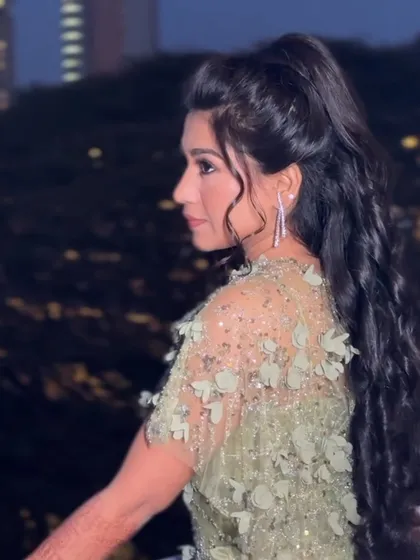 A back view of the half-ponytail, showing the beautiful volume and curls.