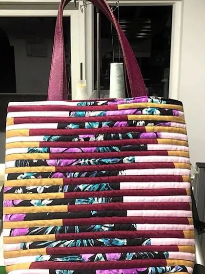 A tote bag created using the Interleave technique, which weaves strips of fabric to create a complex, textured pattern.