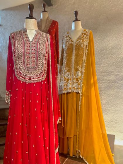 A full view of the red and yellow embroidered kurtas, showcasing their rich textures and festive appeal.