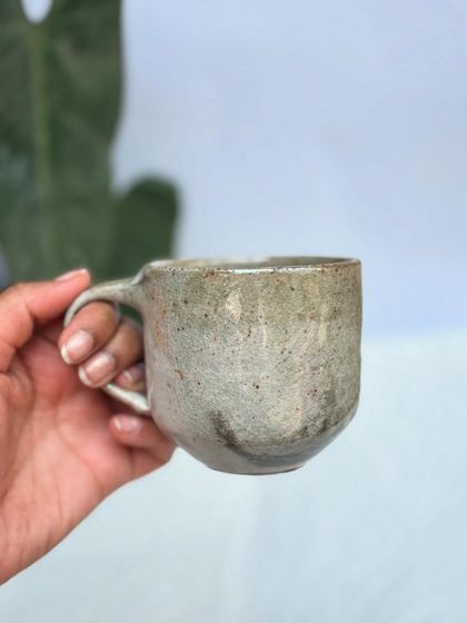 Holding the rounded Shino cup. It’s a comfortable, classic shape for your morning coffee or tea.