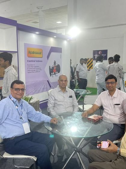 Our leadership team takes a moment to connect with partners at our stall. Building strong, personal relationships is a cornerstone of our business philosophy.