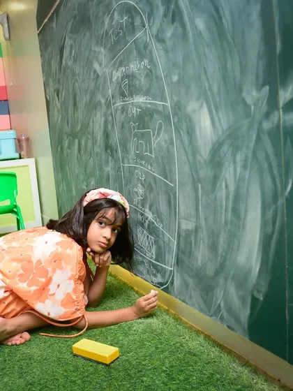 What masterpiece is she creating? Our giant chalkboard wall gives kids a huge canvas to draw, write, and express themselves freely.
