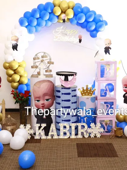 Another look at the Boss Baby first birthday party. The setup includes a mini Ferris wheel prop and a cute picket fence for a charming touch.