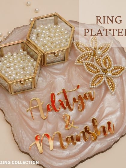 I also design custom ring platters for the engagement ceremony. This one features a beautiful resin platter with personalized names and pearl-filled hexagonal boxes for the rings.