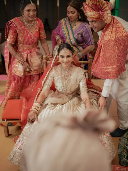 A joyful moment as the bride is carried to the mandap by her family members.
