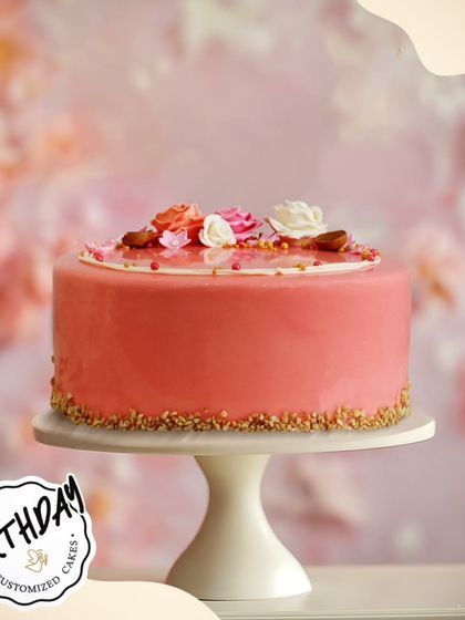 A simple, modern, and elegant cake for Aprajita's birthday in Satya Niketan. The smooth pink glaze is topped with a few delicate flowers and almonds for a chic and sophisticated finish.