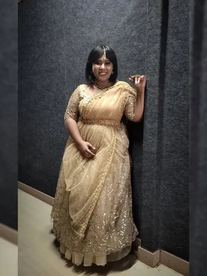 Dressed in a lovely golden lehenga for a special show. This traditional attire is perfect for festive celebrations and weddings.