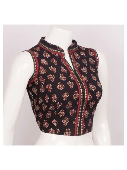 For a contemporary ethnic look, I can create pieces like this sleeveless blouse with a stylish high collar. Made from a classic printed fabric, it is tailored to provide a sharp, flattering fit that pairs well with a variety of sarees.