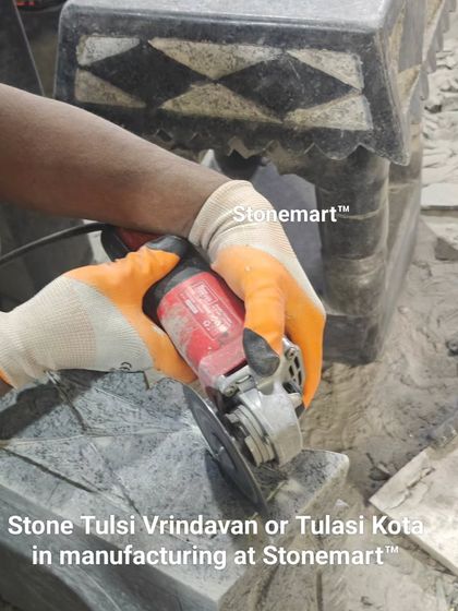 A close-up of an artisan manufacturing a stone Tulsi Vrindavan, or Tulasi Kota. This shows the precision required to carve the delicate patterns into hard granite.