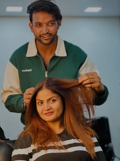 A moment of connection between our stylist and client after a successful transformation.