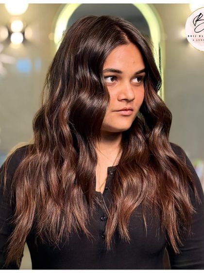 A closer look at the beautiful waves and dimensional brown tones that make this hairstyle a true crown.