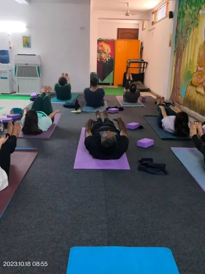 A moment of rest and integration during a group class. We often incorporate gentle supine poses to release tension in the lower back and hips.
