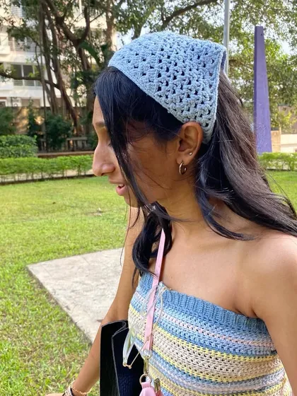 We love pairing our tops with matching accessories. Here, the striped tube top is styled with a handmade blue crochet bandana.