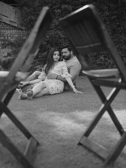 Another angle of the creatively framed black and white shot, capturing the couple in an intimate moment during their pre-wedding shoot.