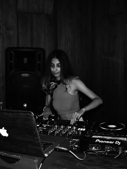 A black and white flashback from a Saturday night gig. The simple, focused shot highlights the connection between the DJ, the music, and the machine.