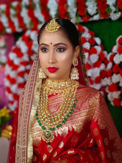 Another beautiful shot of the bride, capturing the elegance and grace of the traditional Bengali bridal look.