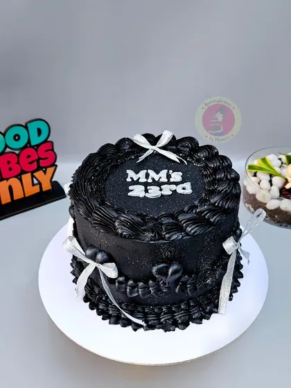 A striking black vintage cake with silver ribbons and glitter, made for a 23rd birthday.