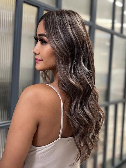 My signature balayage technique creates these beautiful, flowing ribbons of color. This look has amazing dimension and movement, perfect for long, wavy hair.