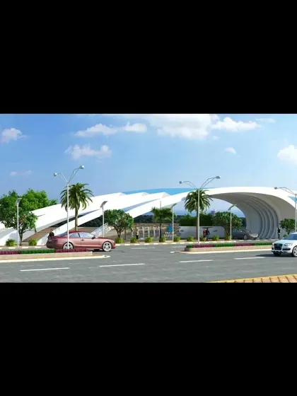A daytime view of the township entrance gate, showing how it frames the entry road. The design is both functional and artistic, setting a premium tone for the entire community.
