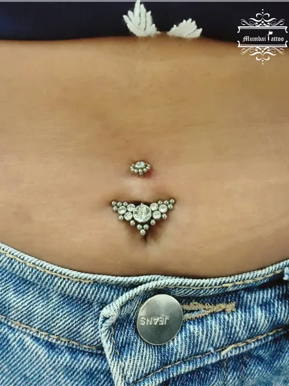 A close-up of a beautifully healed belly piercing featuring our premium, intricate jewelry. We help you select the perfect piece to express your style with confidence.