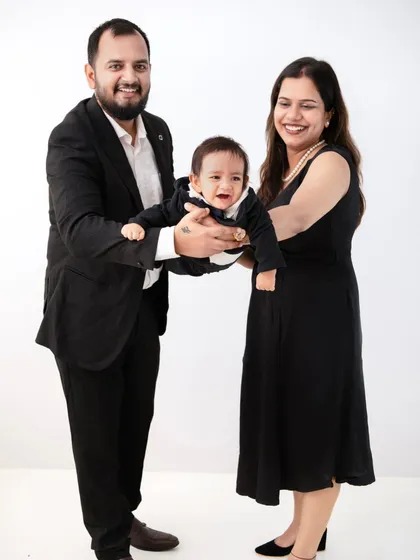 A moment of laughter and fun. This candid shot captures the family playing with their little one, creating a memory filled with happiness.