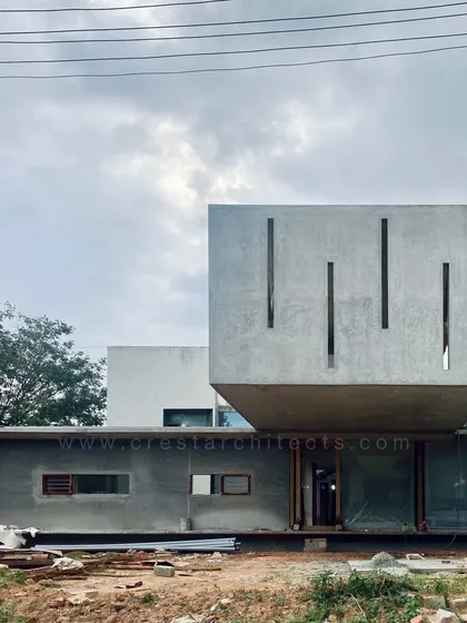 Another construction phase photograph of the Long House, capturing the raw, monolithic quality of the exposed concrete structure against the sky.