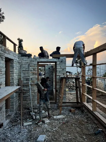 A moment of teamwork as the sun sets over the Himalayan construction site. The process of building here is as much about human connection and shared effort as it is about architecture.