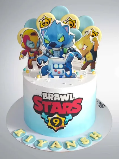 A Brawl Stars themed cake for a 9th birthday. This design features characters from the popular mobile game on a cake with a cool blue ombre effect.