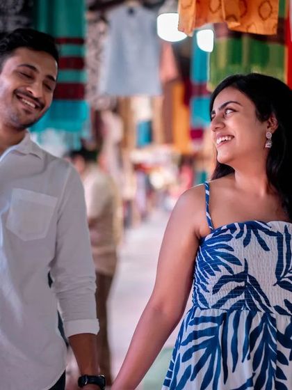 Walking through a bustling market, their focus only on each other. This shot captures a private moment in a public space.