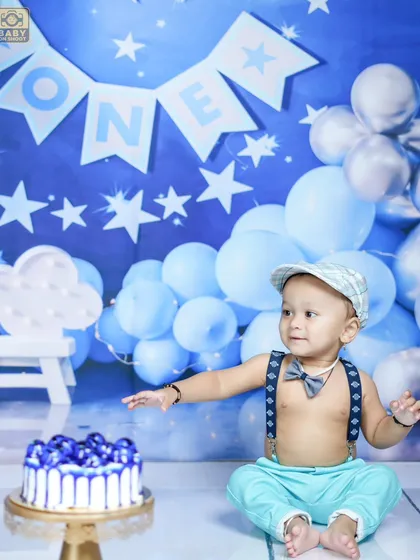 The cake smash is a highlight of any first birthday shoot. This little guy is ready to dig into his blue-themed cake.