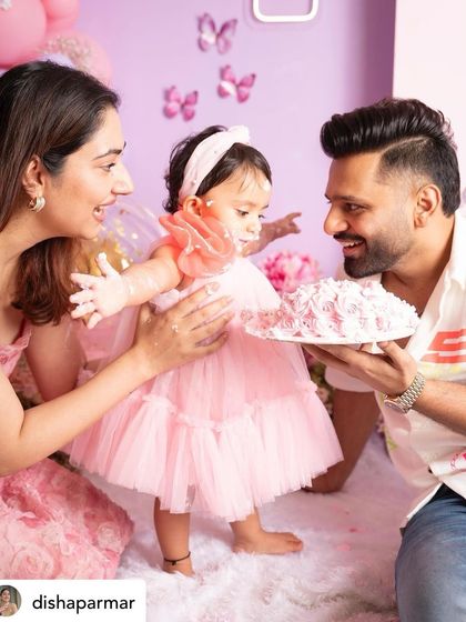 A heartwarming moment from the cake smash, with mom and dad helping their little one get her first taste of cake. Family involvement makes the photos even more special.