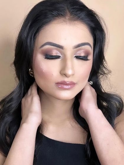 The closed-eye shot highlights the soft brown and champagne tones, a universally flattering combination.