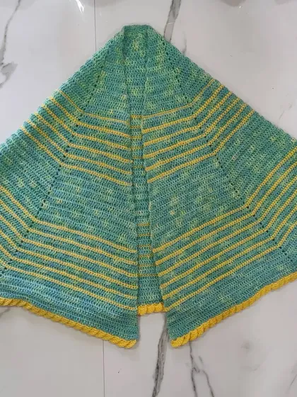 A full, flat view of the lime green and yellow shawl.