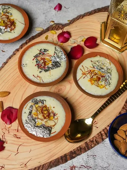 Indulge in the sweet delight of our delicious Firni. Served in traditional clay matkas and garnished with saffron and silver leaf, it's a creamy and aromatic dessert perfect for festive occasions.