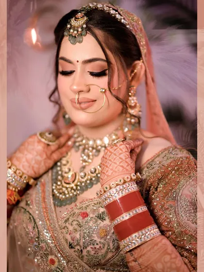 An exquisite bridal portrait capturing the serene beauty of the bride on her wedding day. We focus on the delicate details of her makeup, the intricate wedding jewelry, and the peaceful expression before the ceremonies begin.